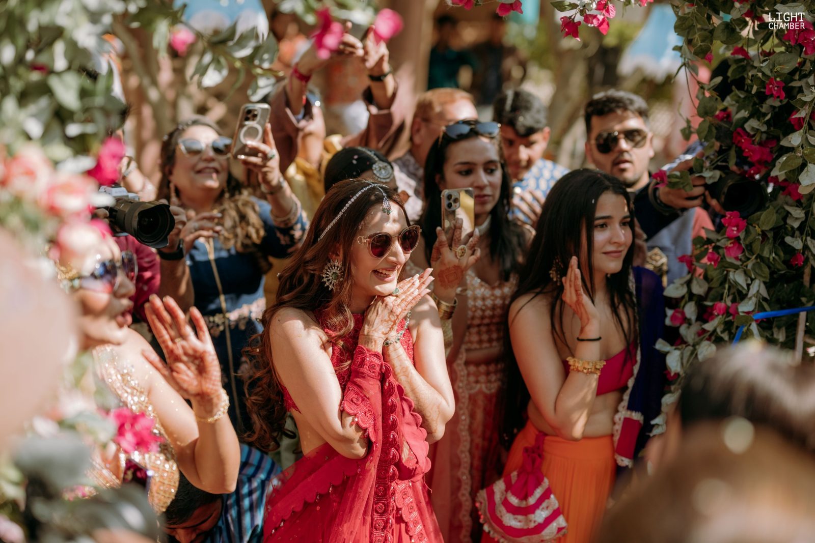Guests mid-celebration, colour and confetti in the air