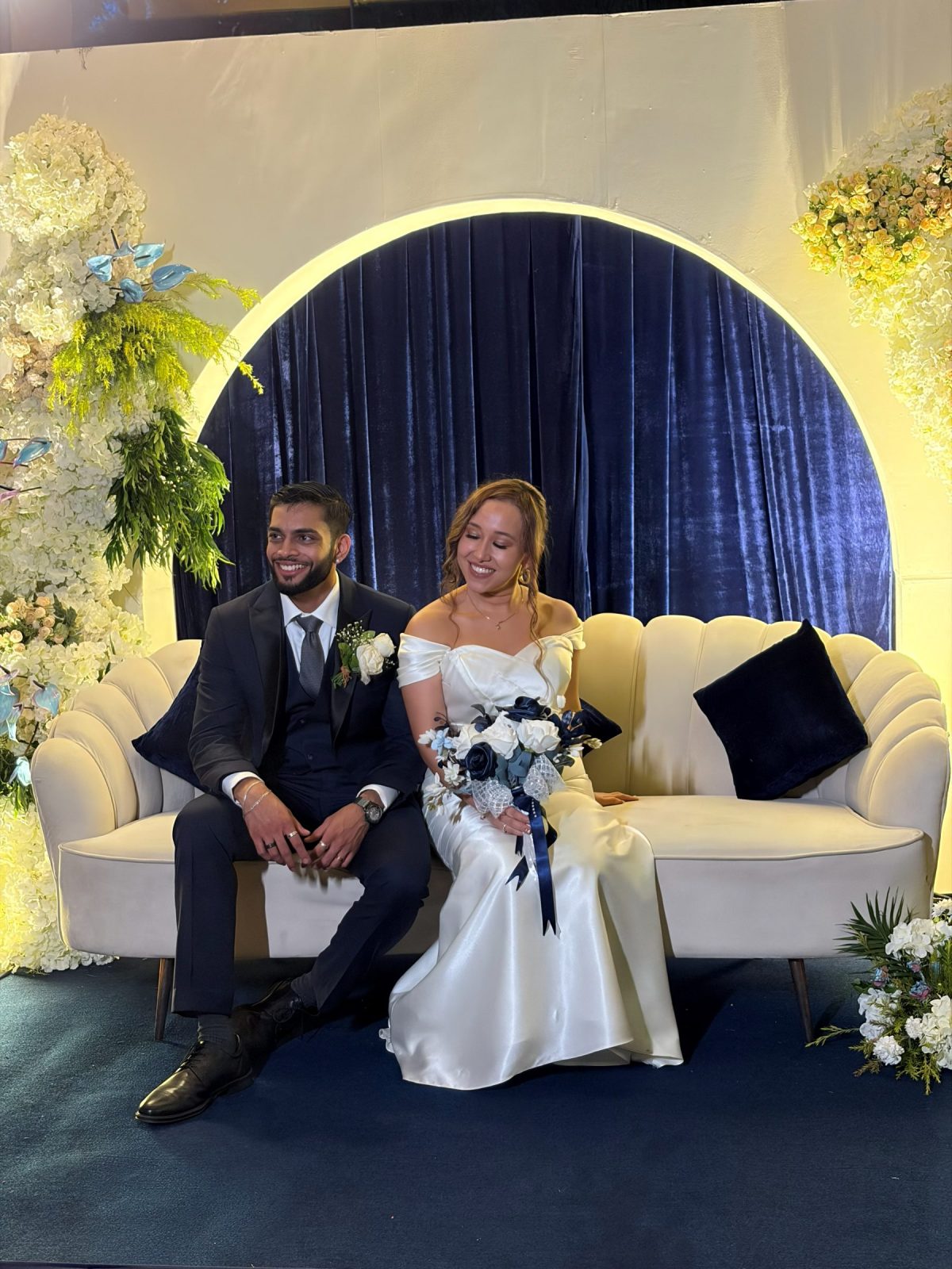 The couple photographed in front of the décor
