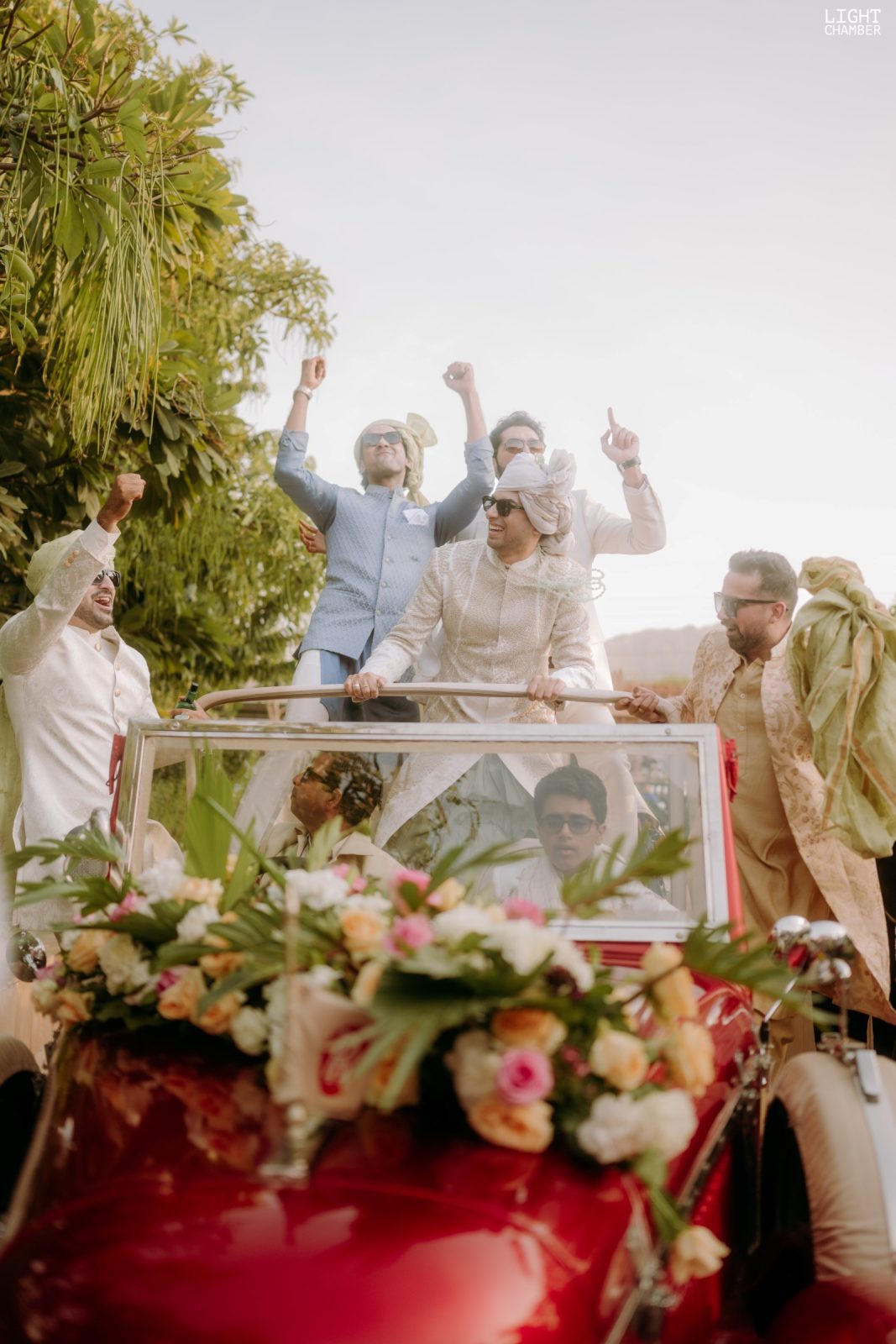 The arrival — a baraat, a decorated vintage car and a flower-lined approach