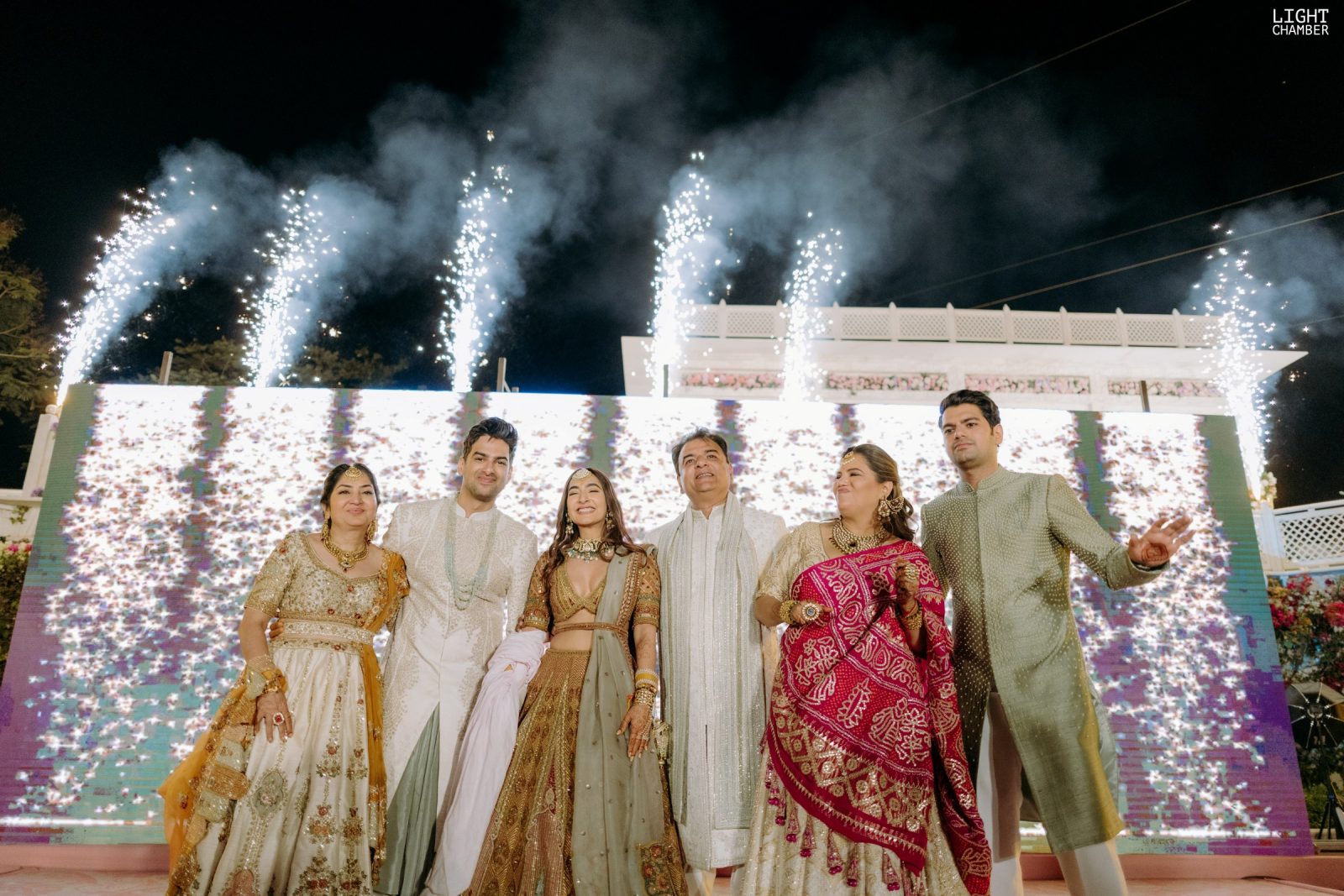 The evening reception — a lit tunnel entry, a ballroom staircase and black-tie guests
