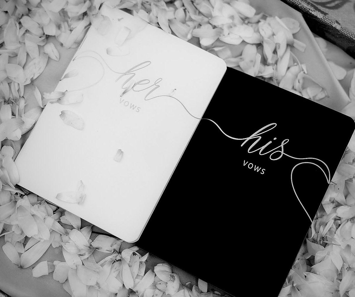 Close detail of the styling — laid tables, stationery, vow books and jewellery