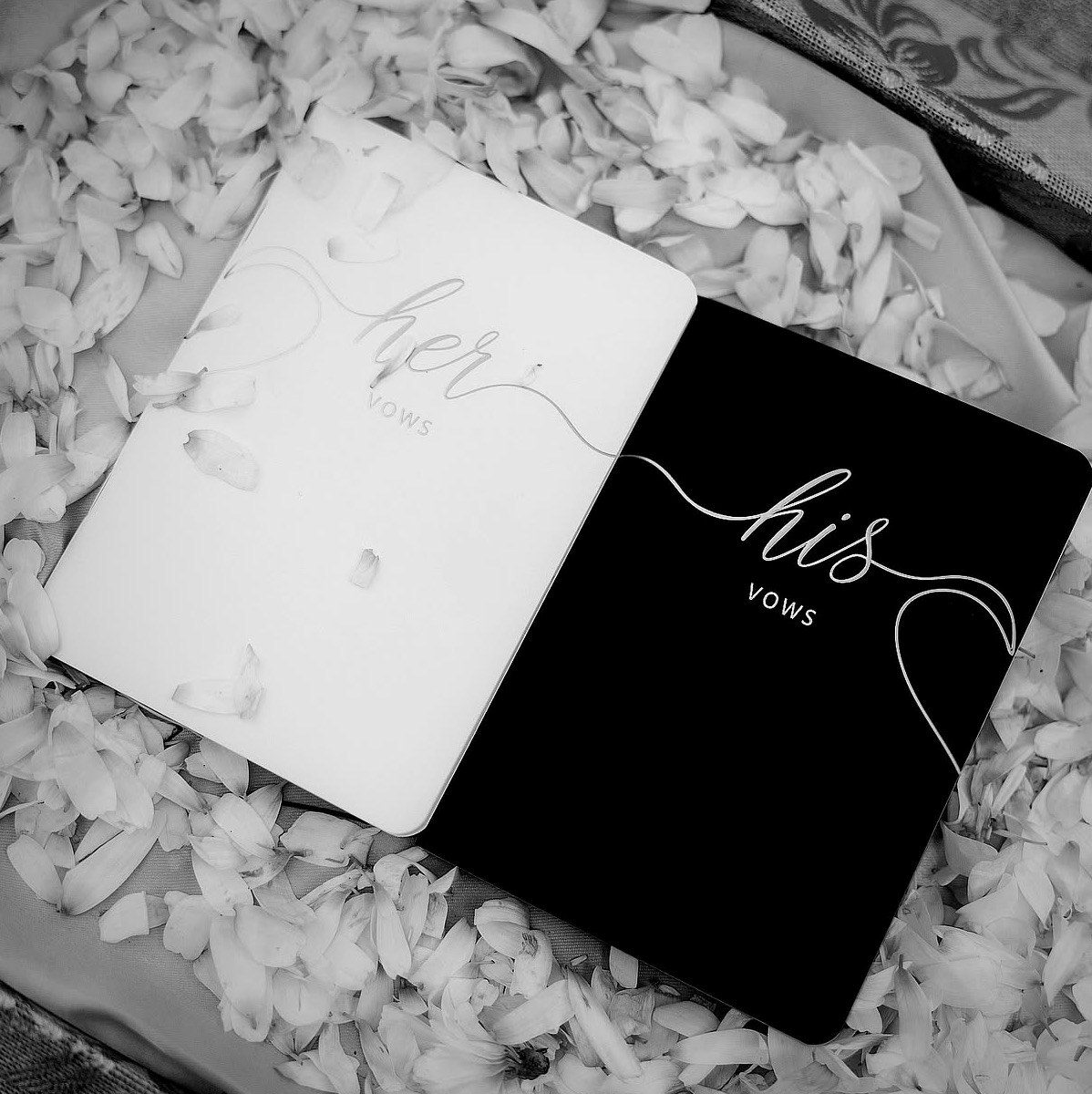 Close detail of the styling — laid tables, stationery, vow books and jewellery