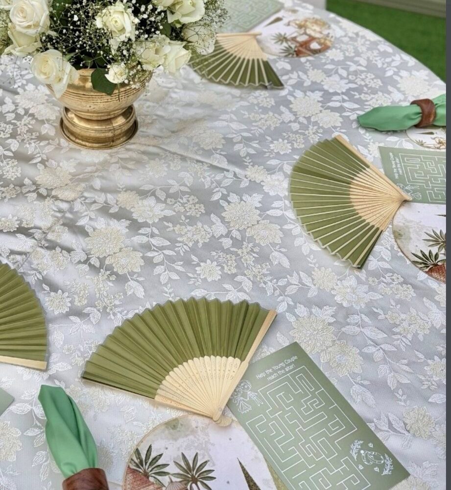 Close detail of the styling — laid tables, stationery, vow books and jewellery
