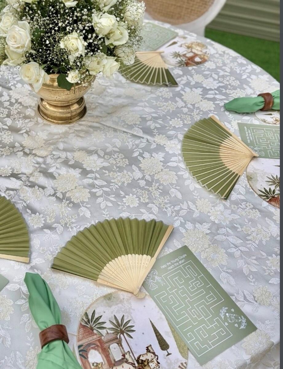 Close detail of the styling — laid tables, stationery, vow books and jewellery